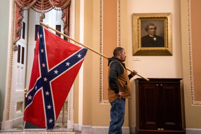 protestor carries confederate flag through U.S. Capitol