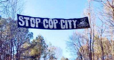 stop cop city banner in trees
